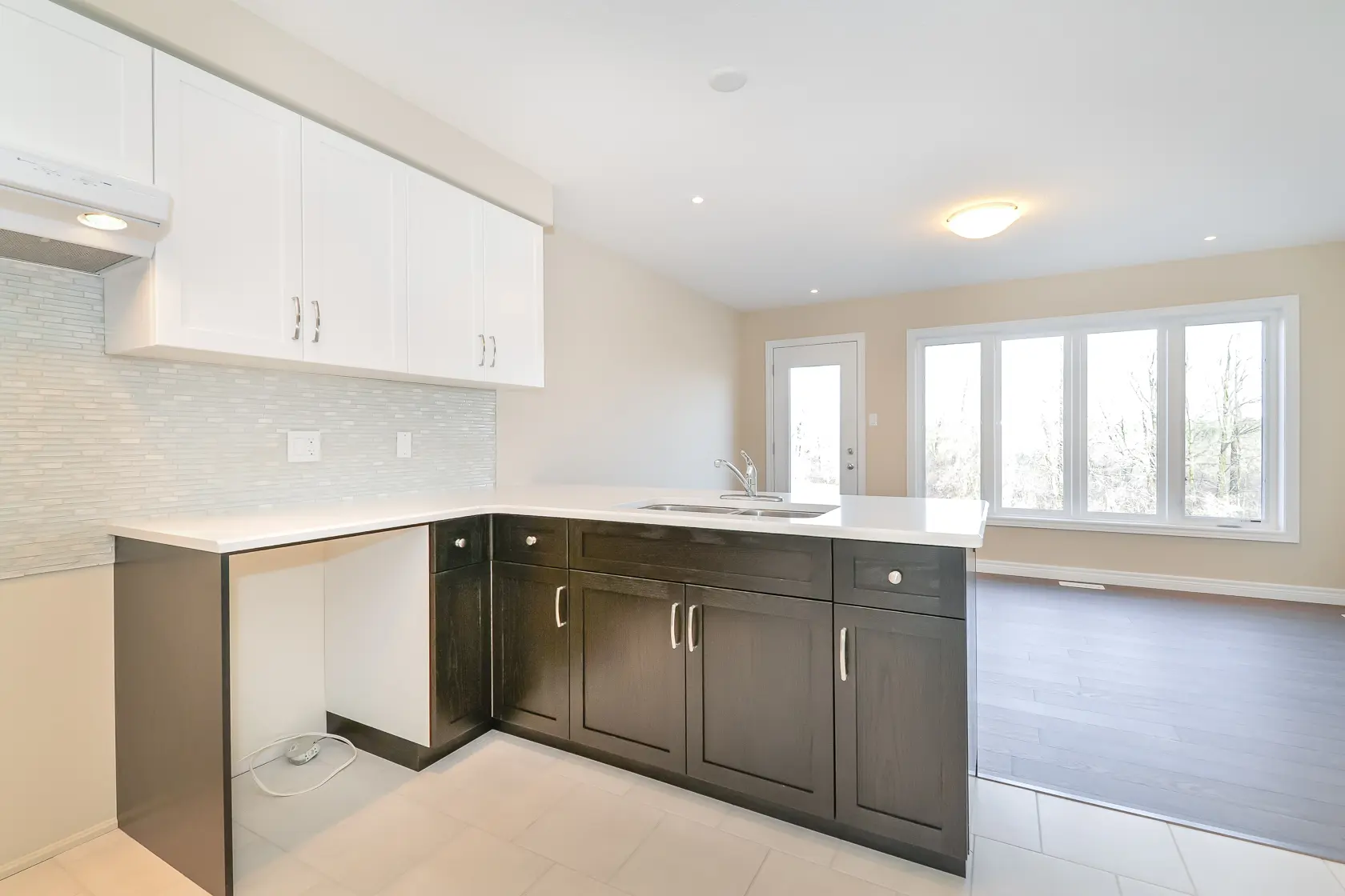 Kitchen with view of cupboards and windows